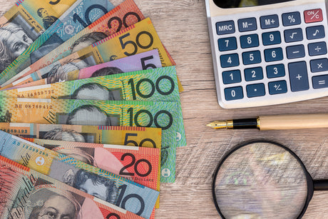 Australian Money, a pen, a calculator and a looking glass